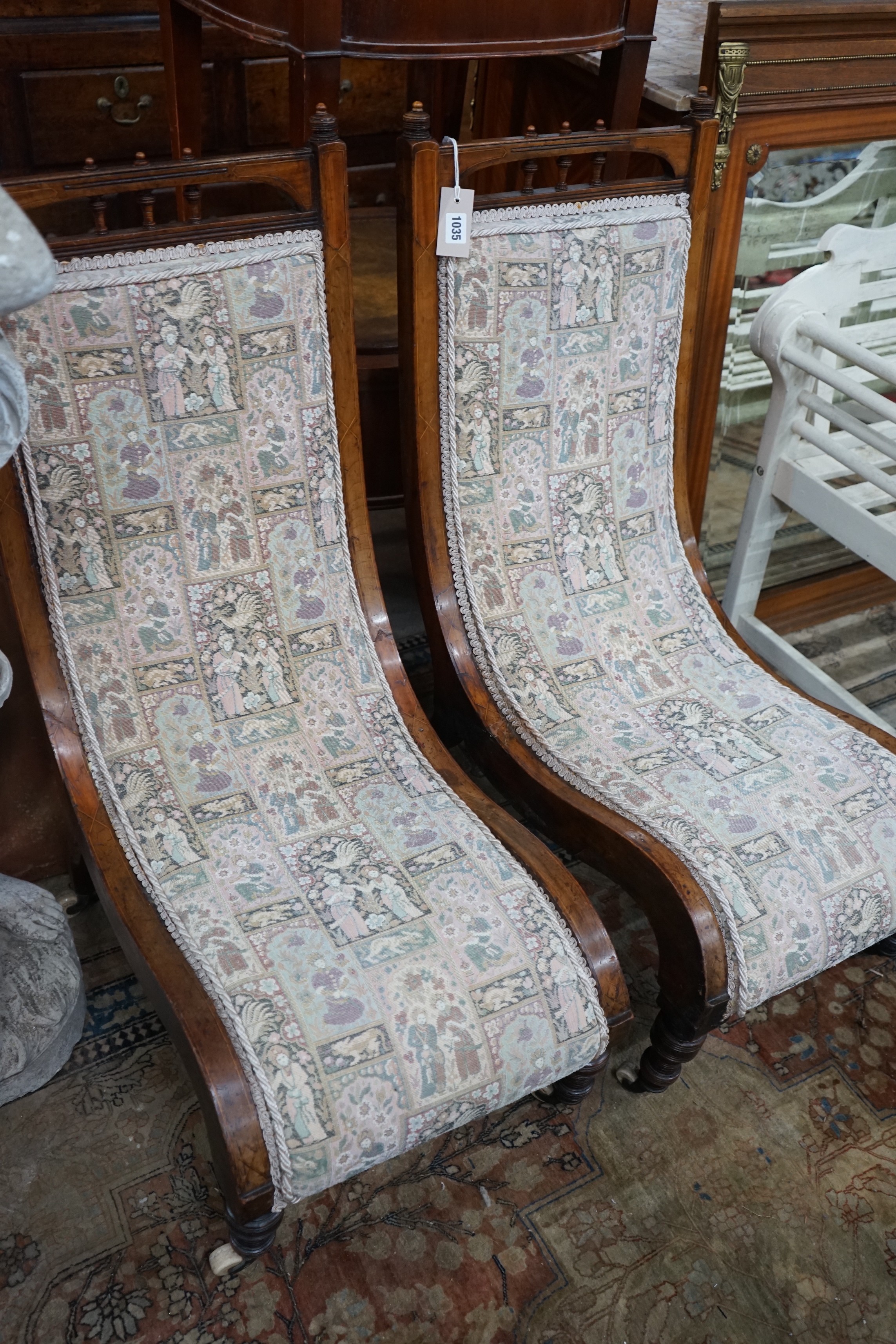 A pair of Victorian inlaid mahogany slipper chairs